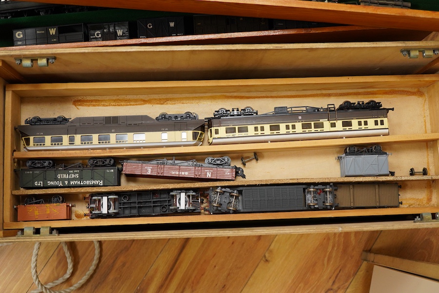 130 items of EM gauge model railway rolling stock contained within three handmade fitted wooden cases, two with removable trays, comprising three locomotives; an SR class 700 0-6-0 tender locomotive, 693, an SR 0-4-0T, 7